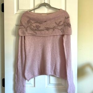 Light lavender/pink sweater with floral embroidery and beating .